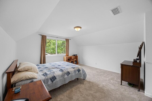 1209 Clearfield Dr, Austin, TX 78758 - carpeted bedroom with lofted ceiling and baseboards