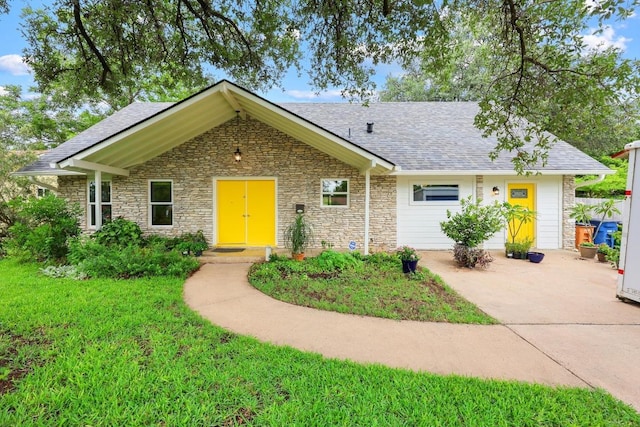 1209 Clearfield Dr, Austin, TX 78758 - single story home with stone siding, roof with shingles, and a front lawn