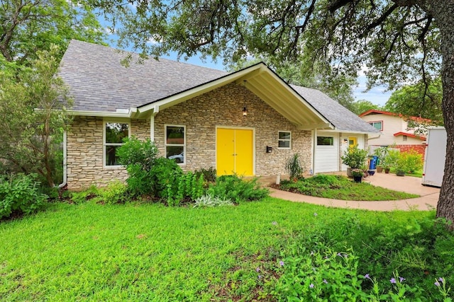1209 Clearfield Dr, Austin, TX 78758 - view of front of property featuring stone siding, a shingled roof, and a front lawn