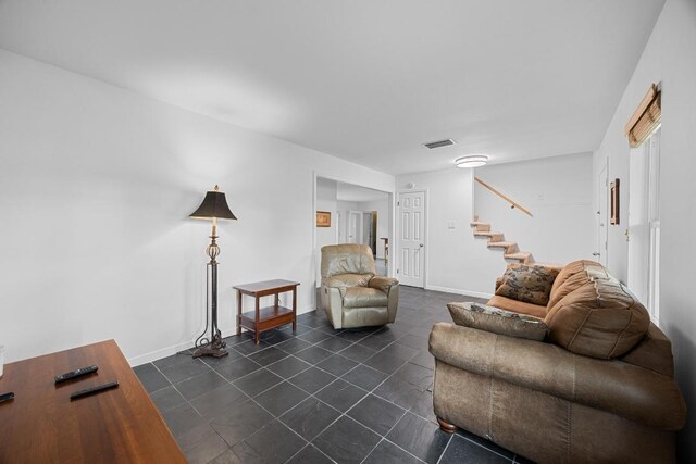1209 Clearfield Dr, Austin, TX 78758 - living room with stairs and dark tile patterned floors