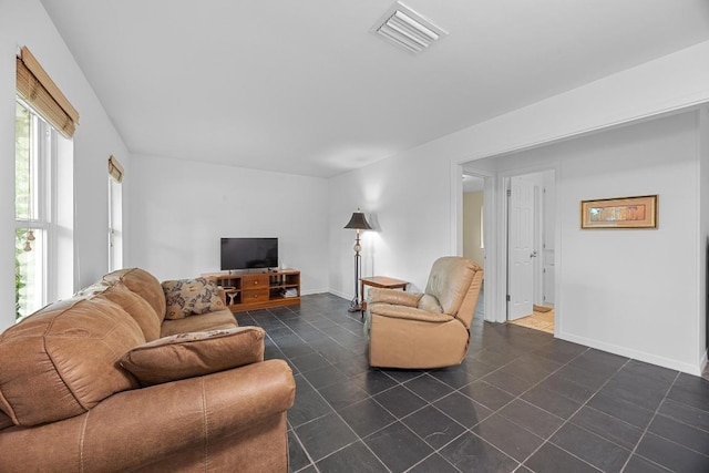 1209 Clearfield Dr, Austin, TX 78758 - living room with dark tile patterned floors and baseboards