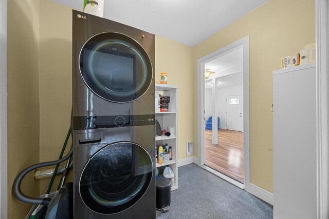 1209 Clearfield Dr, Austin, TX 78758 - laundry area featuring stacked washer and clothes dryer and carpet flooring