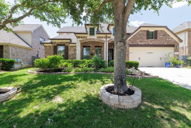 2843 Nolina Ln, Round Rock, TX 78681 - view of front of property with brick siding, driveway, a front yard, and a garage