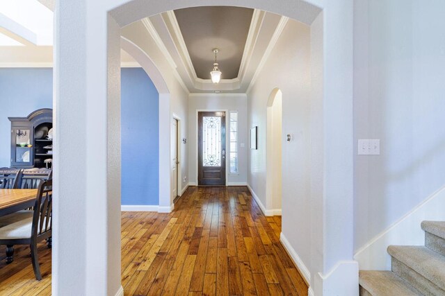 2843 Nolina Ln, Round Rock, TX 78681 - foyer with ornamental molding, hardwood / wood-style floors, arched walkways, a tray ceiling, and stairs