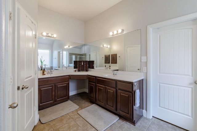 2843 Nolina Ln, Round Rock, TX 78681 - full bath with double vanity, tile patterned floors, and a shower with door