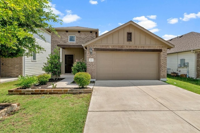 225 Lambert St, Leander, TX 78641 - view of front facade featuring brick siding, an attached garage, concrete driveway, board and batten siding, and a front yard