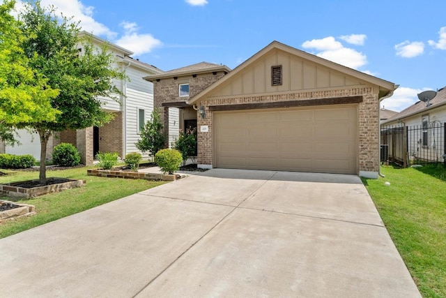 225 Lambert St, Leander, TX 78641 - view of front of property with brick siding, board and batten siding, driveway, and a garage