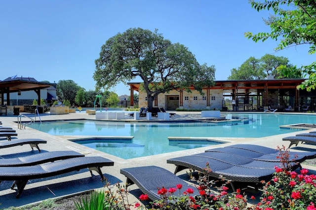 225 Lambert St, Leander, TX 78641 - community pool featuring a jacuzzi, a gazebo, and a patio
