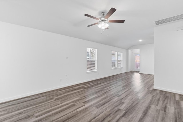 225 Lambert St, Leander, TX 78641 - empty room with vaulted ceiling, wood finished floors, ceiling fan, and recessed lighting