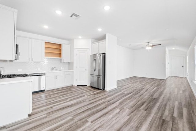 225 Lambert St, Leander, TX 78641 - kitchen with appliances with stainless steel finishes, decorative backsplash, recessed lighting, open shelves, and light wood-style flooring