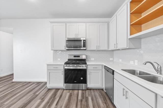 225 Lambert St, Leander, TX 78641 - kitchen featuring stainless steel appliances, wood finished floors, open shelves, and light countertops