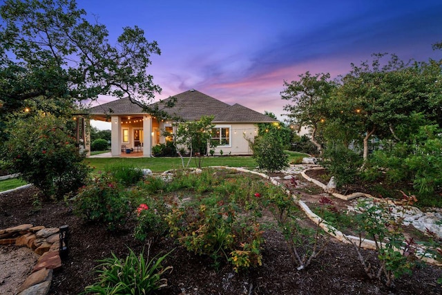 1821 Gilded Crest Dr, Leander, TX 78641 - view of front facade featuring a patio, a lawn, and stucco siding