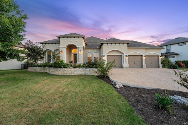 1821 Gilded Crest Dr, Leander, TX 78641 - mediterranean / spanish-style house featuring an attached garage, stucco siding, driveway, and a yard