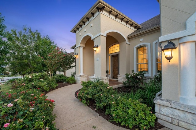1821 Gilded Crest Dr, Leander, TX 78641 - property entrance featuring a porch, stucco siding, a shingled roof, and stone siding