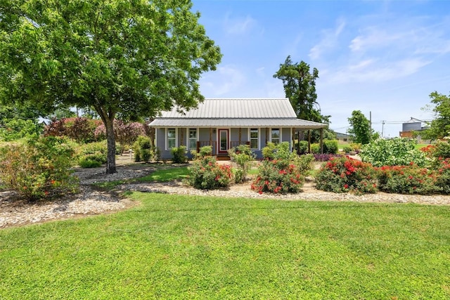 104 S 1st St, Thorndale, TX 76577 - view of front of home with a front yard, a metal roof, and a porch