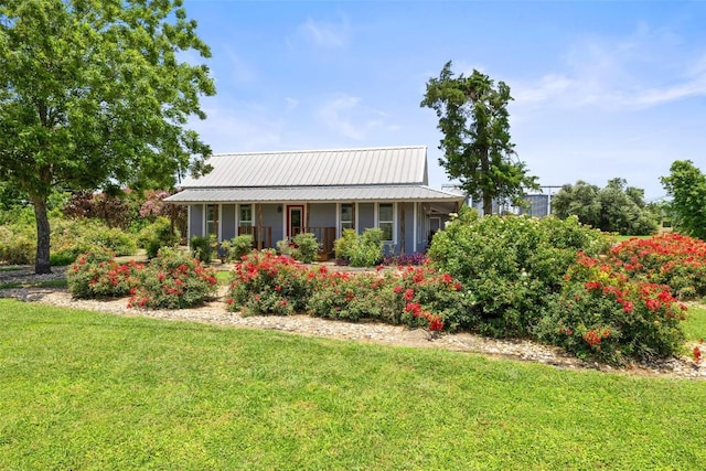 104 S 1st St, Thorndale, TX 76577 - view of front facade with a front yard and a metal roof