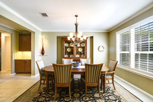 203 Mustang Island Trl, Georgetown, TX 78633 - dining space with a chandelier, light tile patterned floors, and ornamental molding