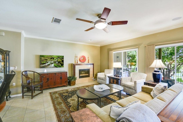 203 Mustang Island Trl, Georgetown, TX 78633 - living area with ceiling fan, light tile patterned floors, a tile fireplace, and crown molding