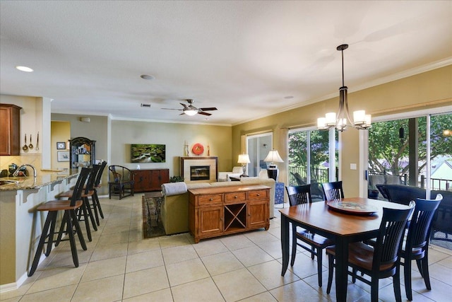 203 Mustang Island Trl, Georgetown, TX 78633 - dining space featuring crown molding, a ceiling fan, a chandelier, and light tile patterned flooring