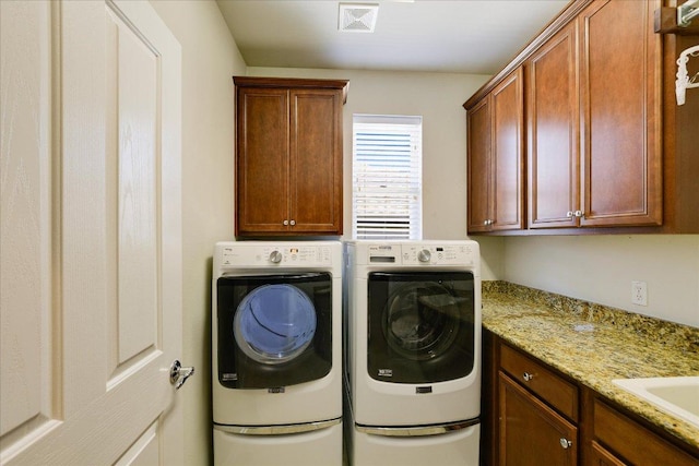 203 Mustang Island Trl, Georgetown, TX 78633 - washroom with cabinet space and washing machine and clothes dryer