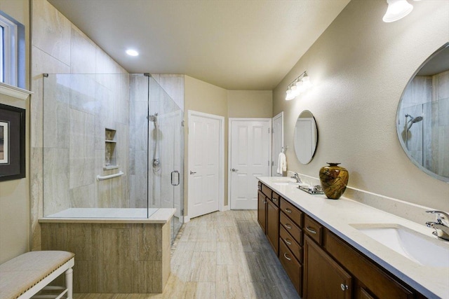 203 Mustang Island Trl, Georgetown, TX 78633 - bathroom featuring a stall shower, double vanity, and wood finished floors