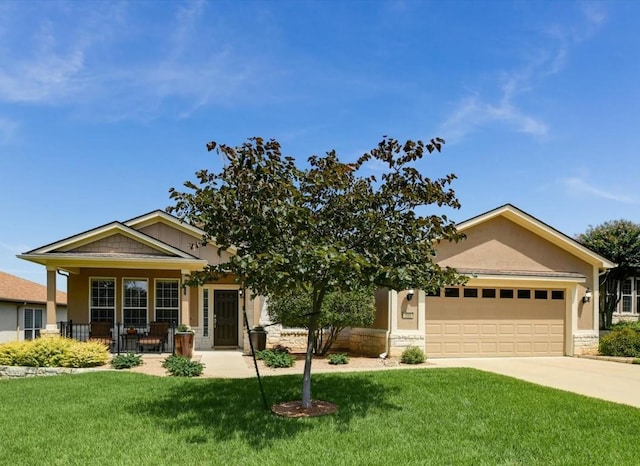 203 Mustang Island Trl, Georgetown, TX 78633 - view of front of house featuring a front yard, a garage, covered porch, and stucco siding