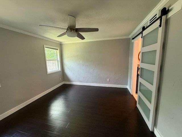 6609 Capriola Dr, Austin, TX 78745 - unfurnished room with a barn door, ceiling fan, ornamental molding, and dark wood-style floors