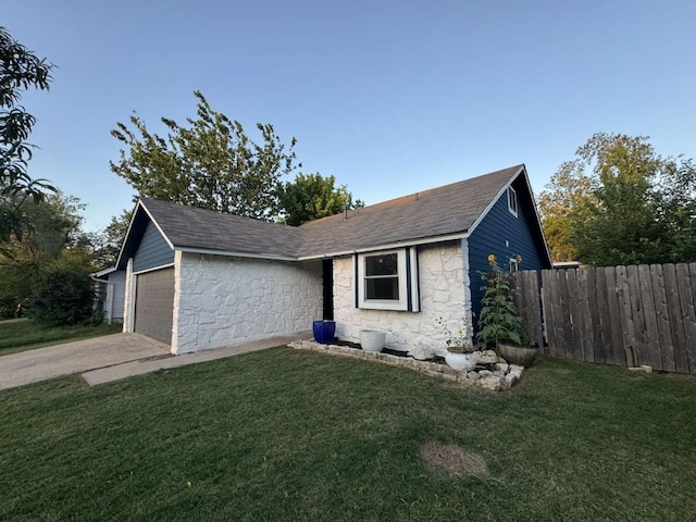 6609 Capriola Dr, Austin, TX 78745 - ranch-style house with stone siding, a shingled roof, an attached garage, and driveway