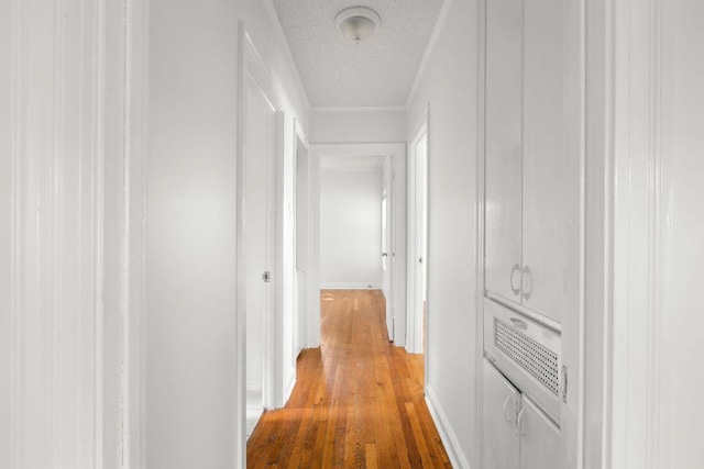 506 W 51st St Unit A, Austin, TX 78751 - corridor featuring light wood finished floors, ornamental molding, and a textured ceiling