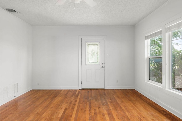 506 W 51st St Unit A, Austin, TX 78751 - unfurnished room with a textured ceiling, wood finished floors, and a ceiling fan
