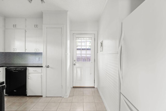 506 W 51st St Unit A, Austin, TX 78751 - kitchen with black dishwasher, freestanding refrigerator, dark countertops, white cabinets, and a textured ceiling