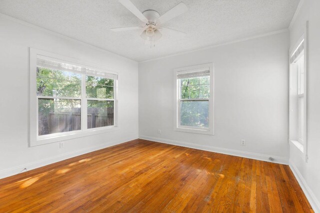 506 W 51st St Unit A, Austin, TX 78751 - empty room with hardwood / wood-style floors, a textured ceiling, ornamental molding, and ceiling fan