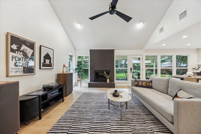 11308 Toledo Dr, Austin, TX 78759 - living area with high vaulted ceiling, a ceiling fan, a fireplace, recessed lighting, and light wood-type flooring