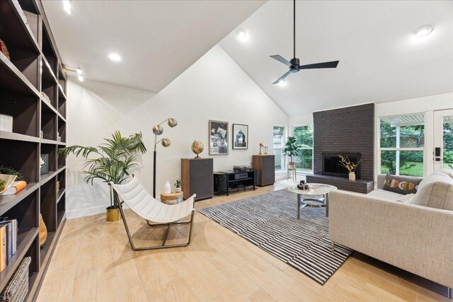 11308 Toledo Dr, Austin, TX 78759 - living room featuring ceiling fan, a brick fireplace, plenty of natural light, high vaulted ceiling, and wood finished floors