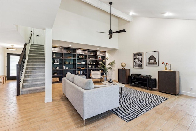 11308 Toledo Dr, Austin, TX 78759 - living room with stairway, beam ceiling, wood finished floors, a ceiling fan, and high vaulted ceiling