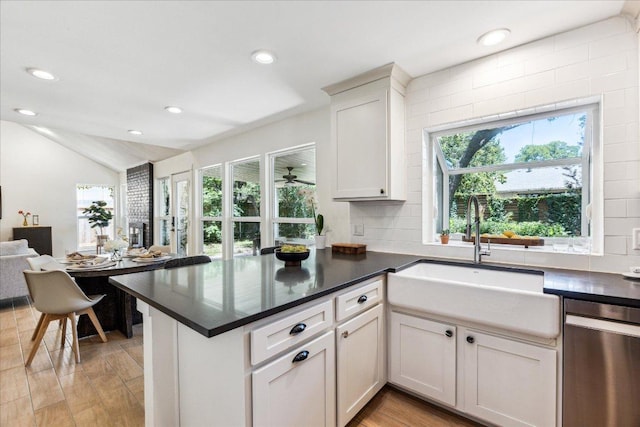 11308 Toledo Dr, Austin, TX 78759 - kitchen with stainless steel dishwasher, dark countertops, recessed lighting, backsplash, and lofted ceiling
