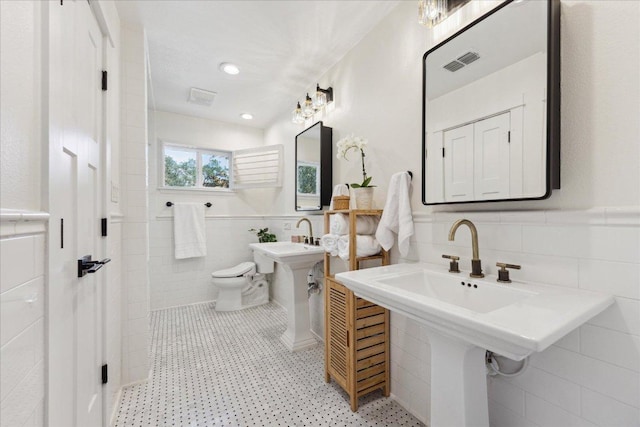11308 Toledo Dr, Austin, TX 78759 - bathroom featuring tile walls and wainscoting