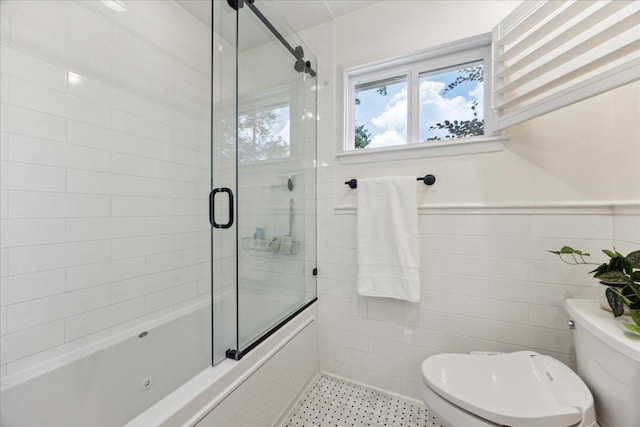 11308 Toledo Dr, Austin, TX 78759 - bathroom with enclosed tub / shower combo, tile walls, and a wainscoted wall