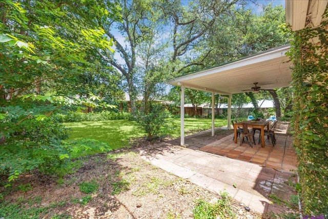 11308 Toledo Dr, Austin, TX 78759 - fenced backyard with ceiling fan, a patio, and outdoor dining area