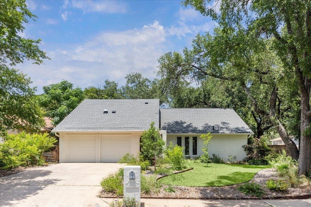 11308 Toledo Dr, Austin, TX 78759 - mid-century modern home featuring brick siding, an attached garage, concrete driveway, a front lawn, and a shingled roof