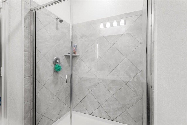 239 Crimson Ln, Kyle, TX 78640 - full bathroom featuring a shower stall