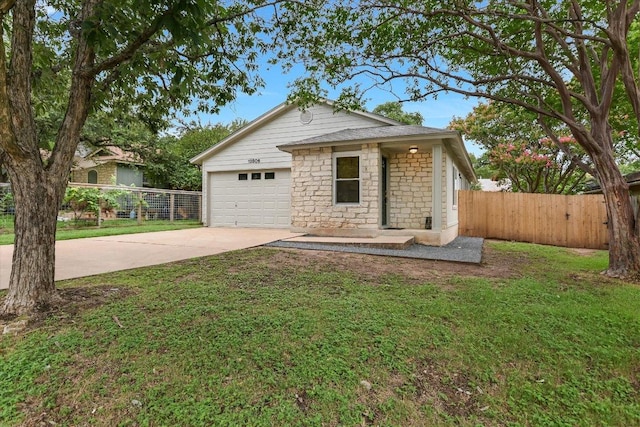 12806 Heinemann Dr, Austin, TX 78727 - view of front of house with driveway, an attached garage, and stone siding