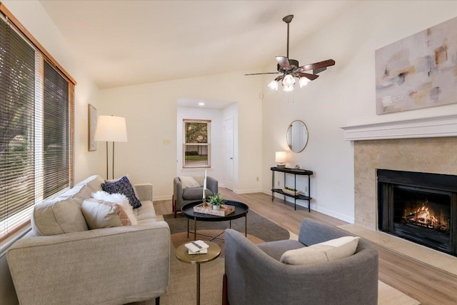 12806 Heinemann Dr, Austin, TX 78727 - living area with wood finished floors, vaulted ceiling, a premium fireplace, and a ceiling fan