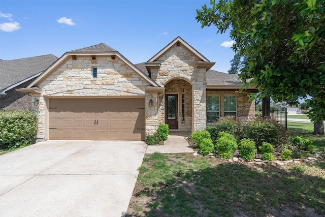 7901 Arbor Knoll Ct, Lago Vista, TX 78645 - french country home featuring an attached garage, stone siding, and driveway