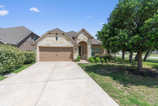 7901 Arbor Knoll Ct, Lago Vista, TX 78645 - french country style house featuring stone siding, an attached garage, concrete driveway, and a front lawn