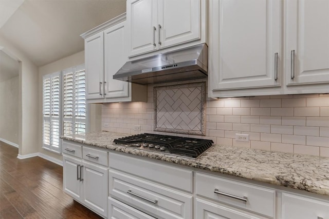 7901 Arbor Knoll Ct, Lago Vista, TX 78645 - kitchen featuring under cabinet range hood, stainless steel gas stovetop, dark wood finished floors, white cabinets, and tasteful backsplash