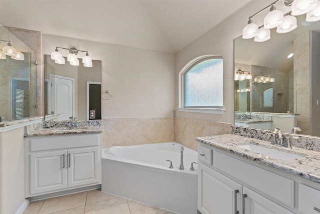 7901 Arbor Knoll Ct, Lago Vista, TX 78645 - bathroom with vaulted ceiling, a stall shower, two vanities, tile patterned flooring, and a bath