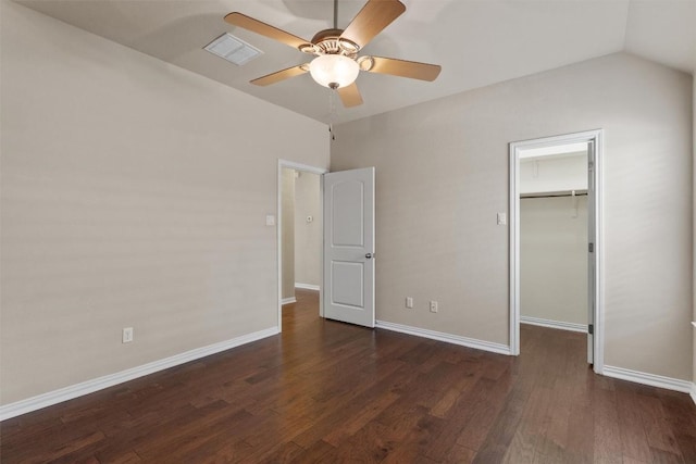 7901 Arbor Knoll Ct, Lago Vista, TX 78645 - unfurnished bedroom with a walk in closet, wood finished floors, a closet, a ceiling fan, and vaulted ceiling