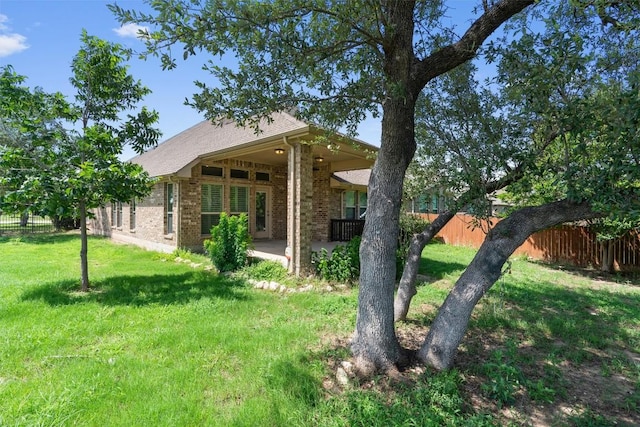 7901 Arbor Knoll Ct, Lago Vista, TX 78645 - rear view of property featuring brick siding and a patio