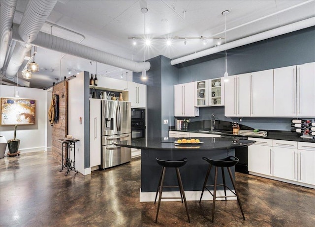 311 W 5th St Unit 1008, Austin, TX 78701 - kitchen featuring black appliances, dark countertops, a kitchen breakfast bar, white cabinets, and a towering ceiling